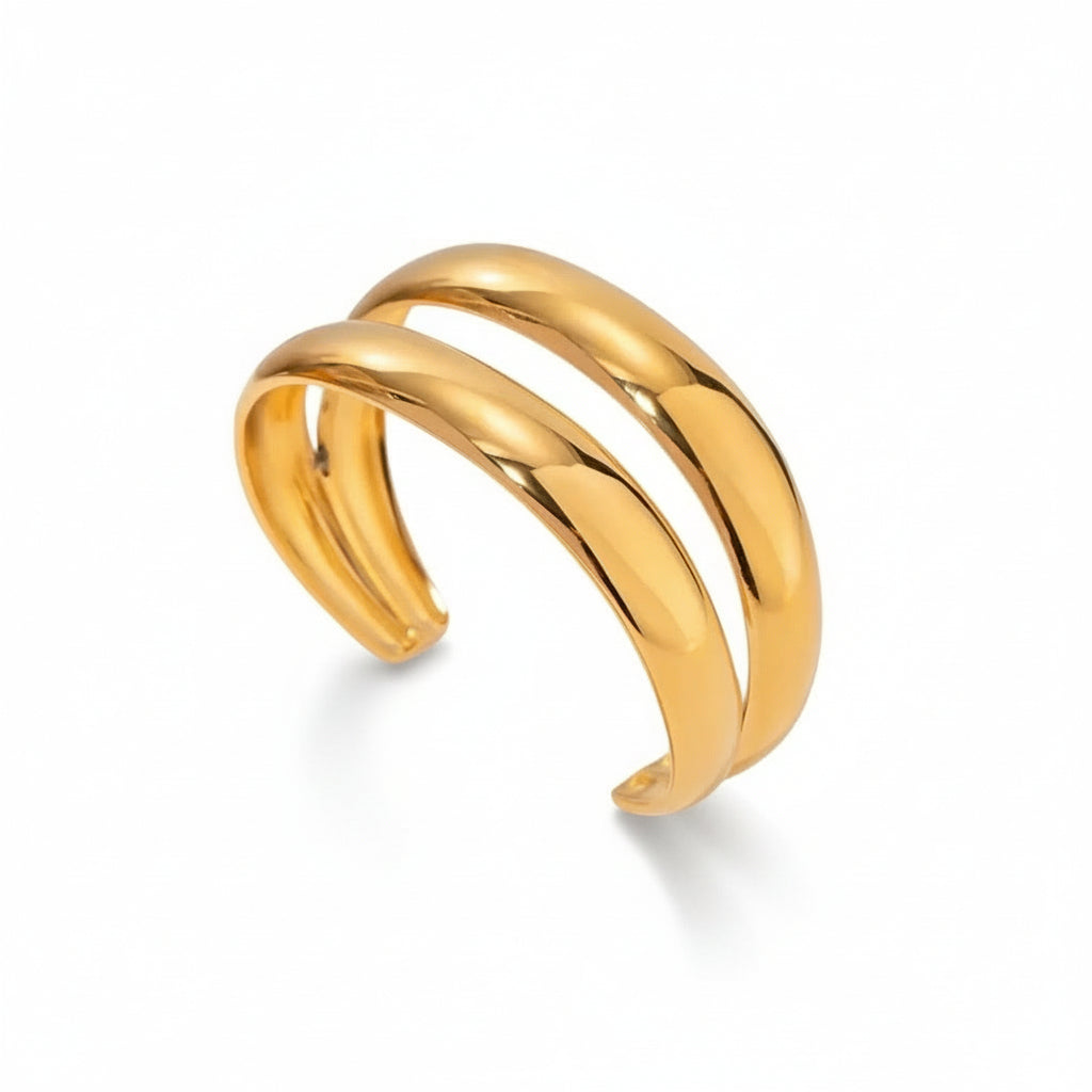 A gold-plated double cuff bracelet with a smooth, shiny finish.