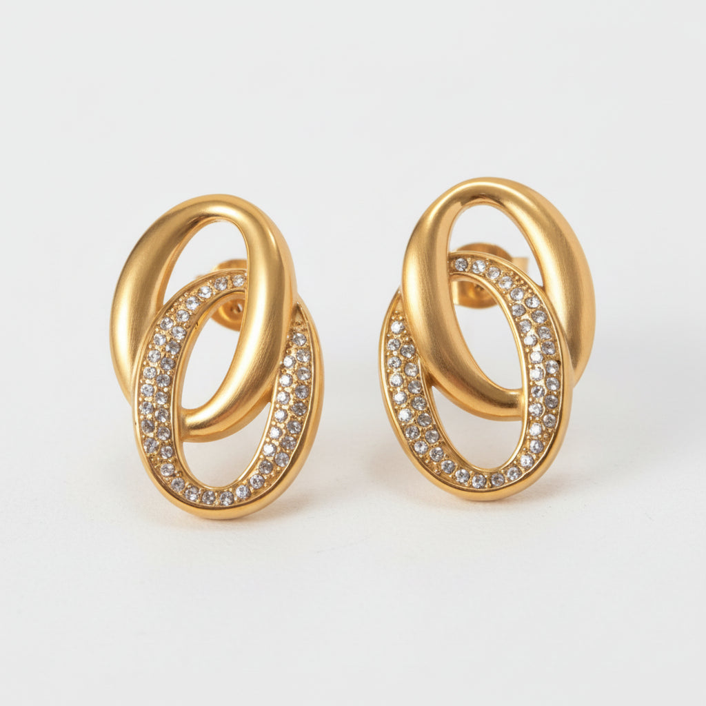 A pair of gold-plated double hoop earrings with rhinestone embellishments.