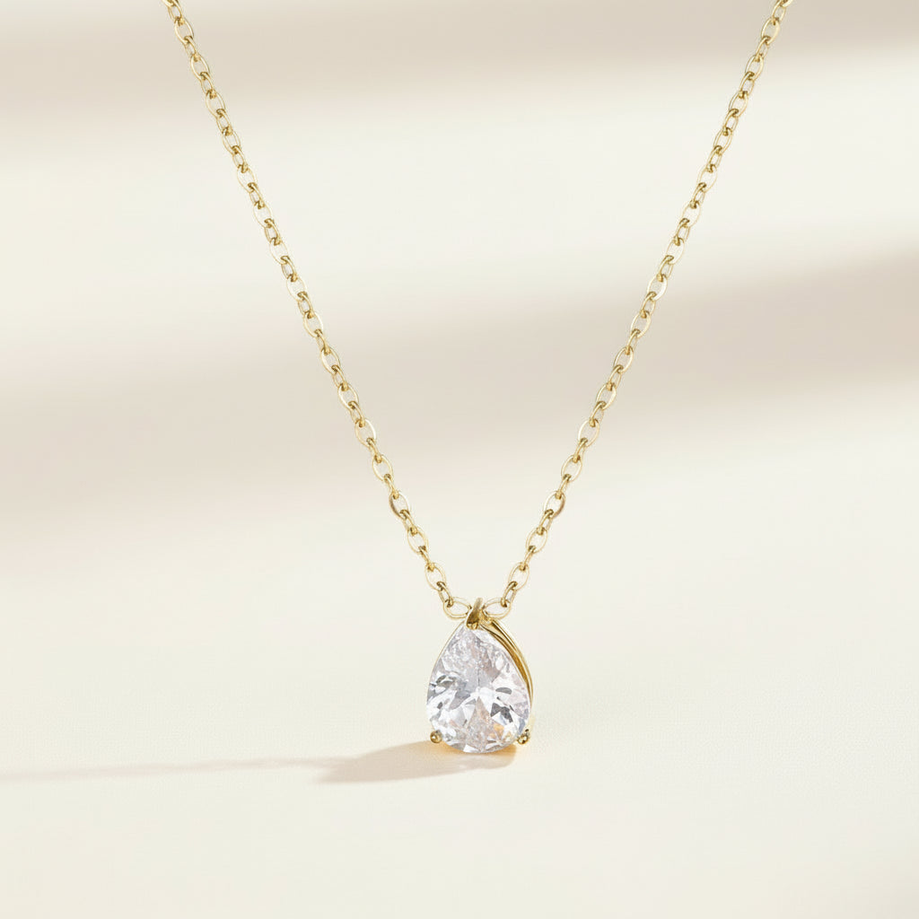 Gold necklace with a teardrop-shaped zircon stone pendant